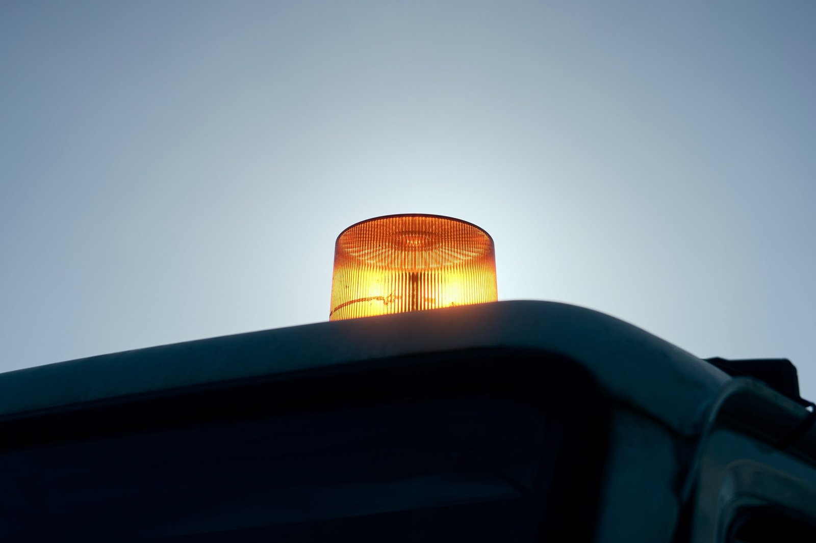 Close-up of a car windshield with a small chip being inspected by a professional technician, emphasizing preventative maintenance.
