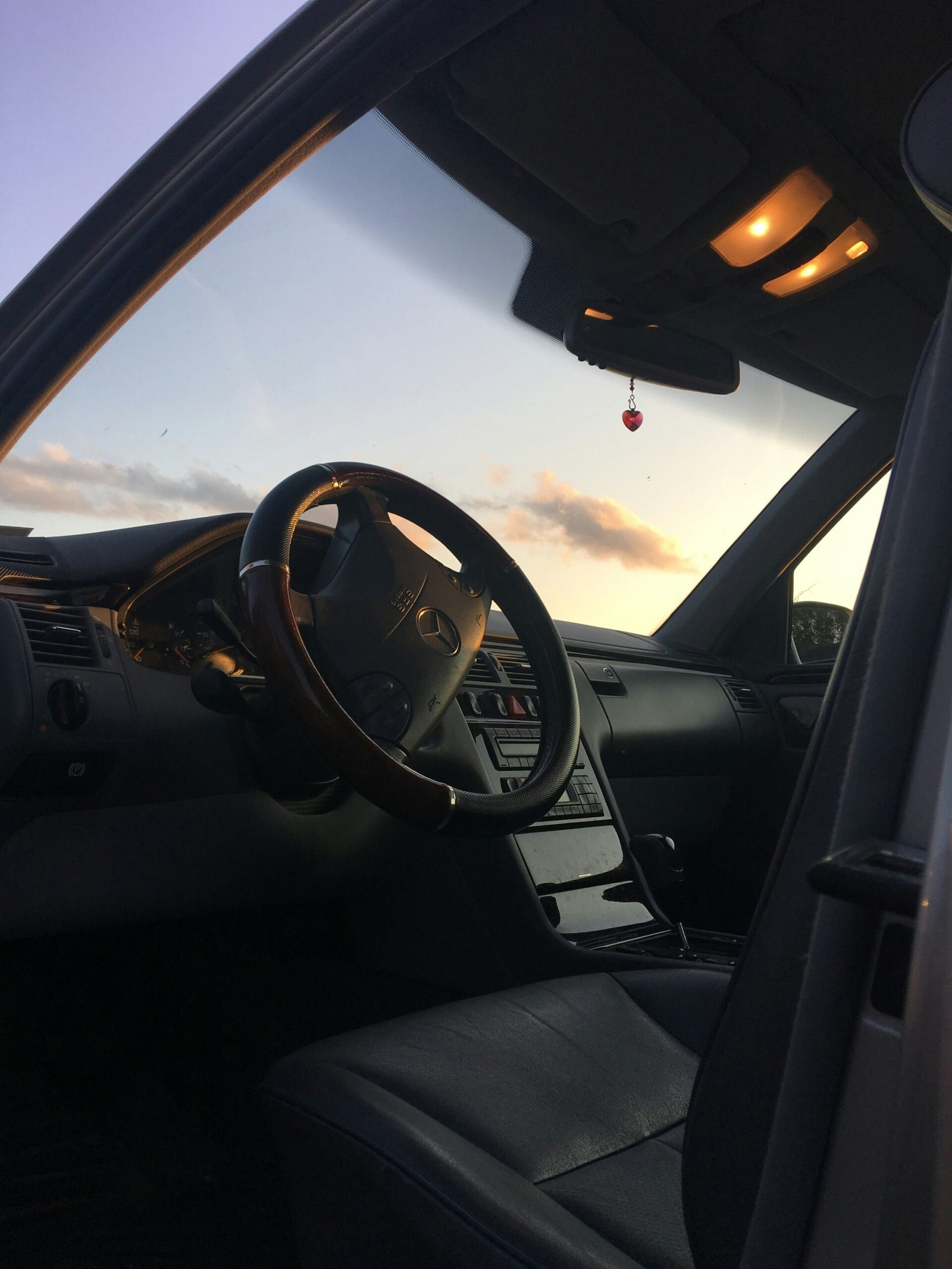 Close-up shot of a car dashboard with no warning lights on, steering wheel in focus