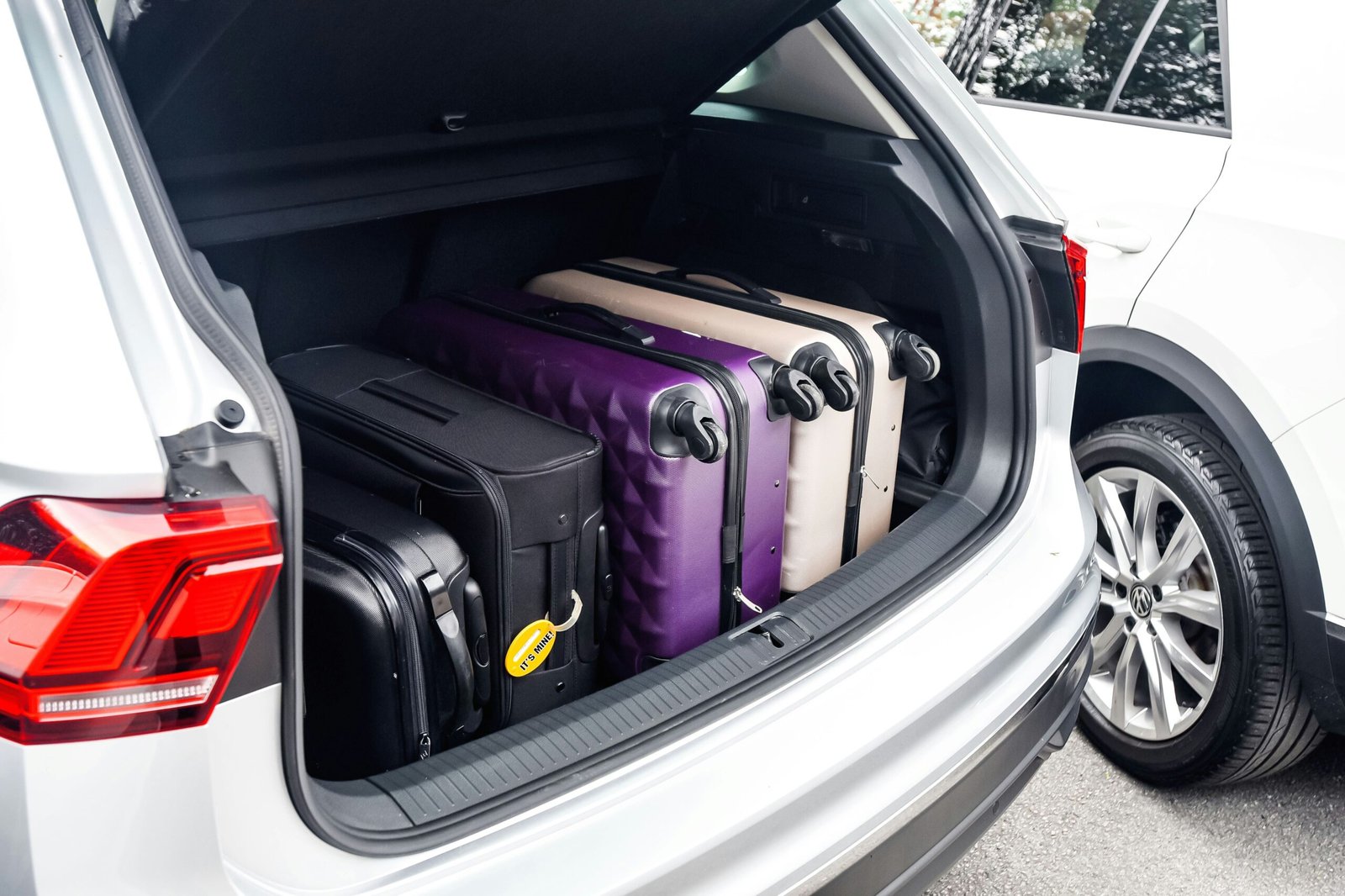 organized car trunk with luggage net and packed bags