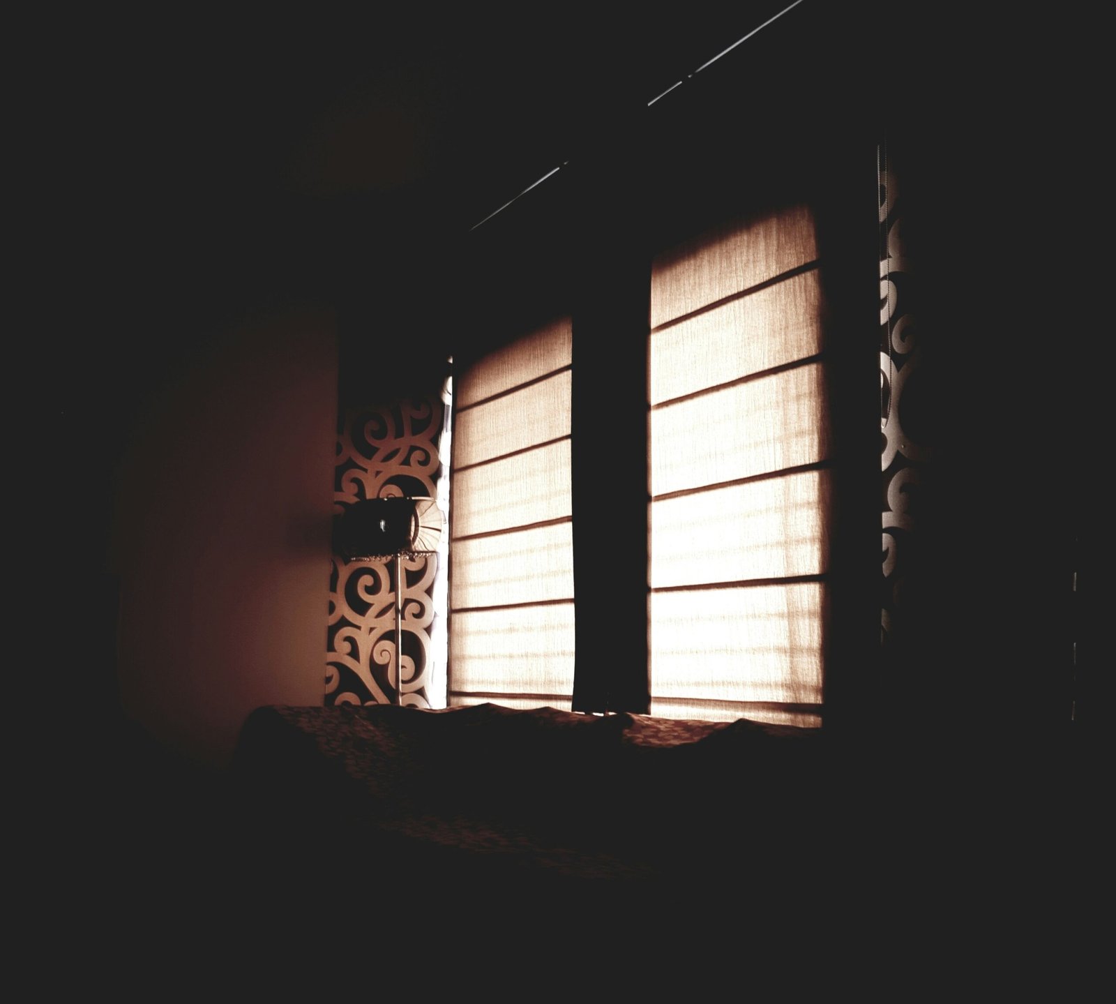 High end black SUV parked in front of a modern building in Lausanne with dark tinted windows