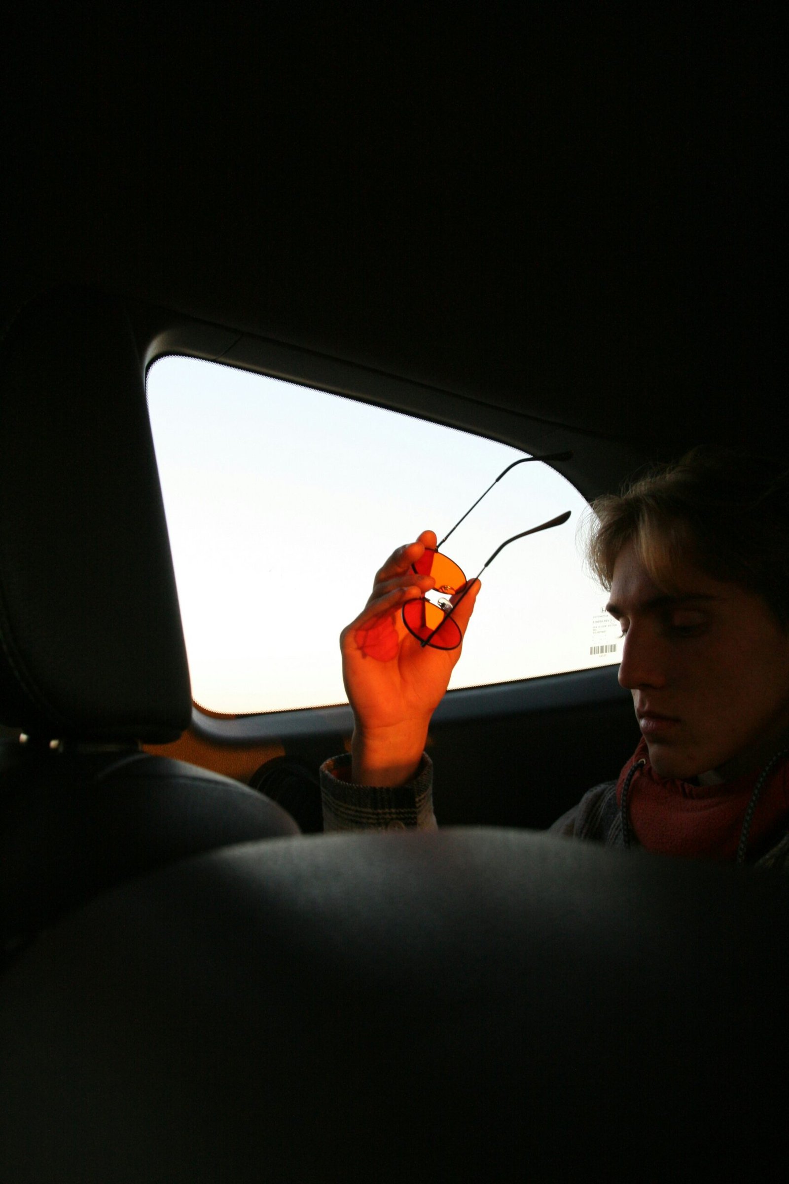 Close up of a professional applying tint film on a car window with precision tools