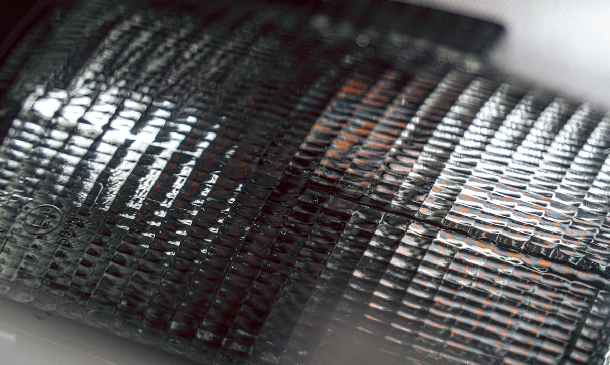 Close-up of a textured metallic surface with repeating patterns