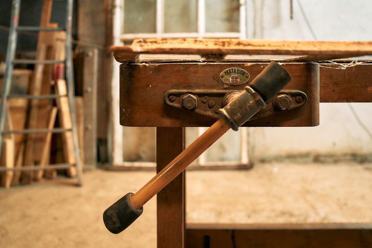 A hammer is stuck into a piece of wood