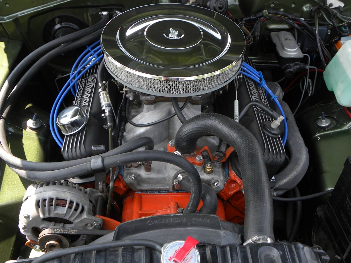 A close up of a car engine with its hood up