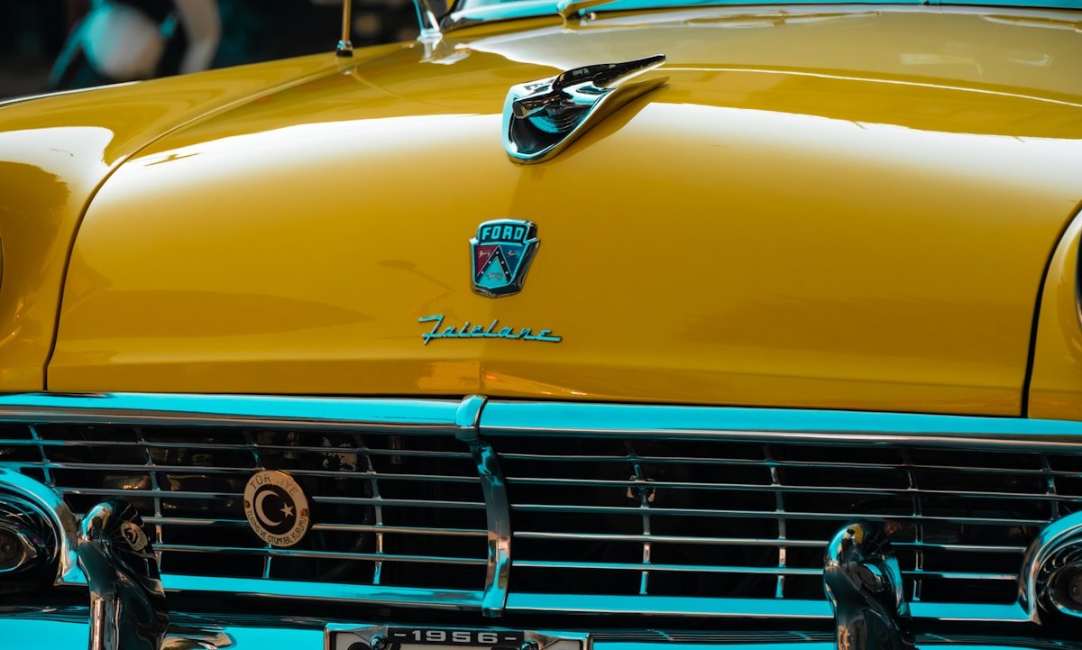 Close-up of a vintage yellow ford fairlane car.