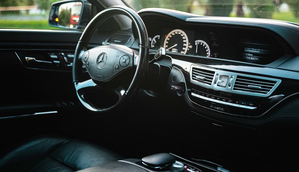 Luxury car interior with dashboard and steering wheel.
