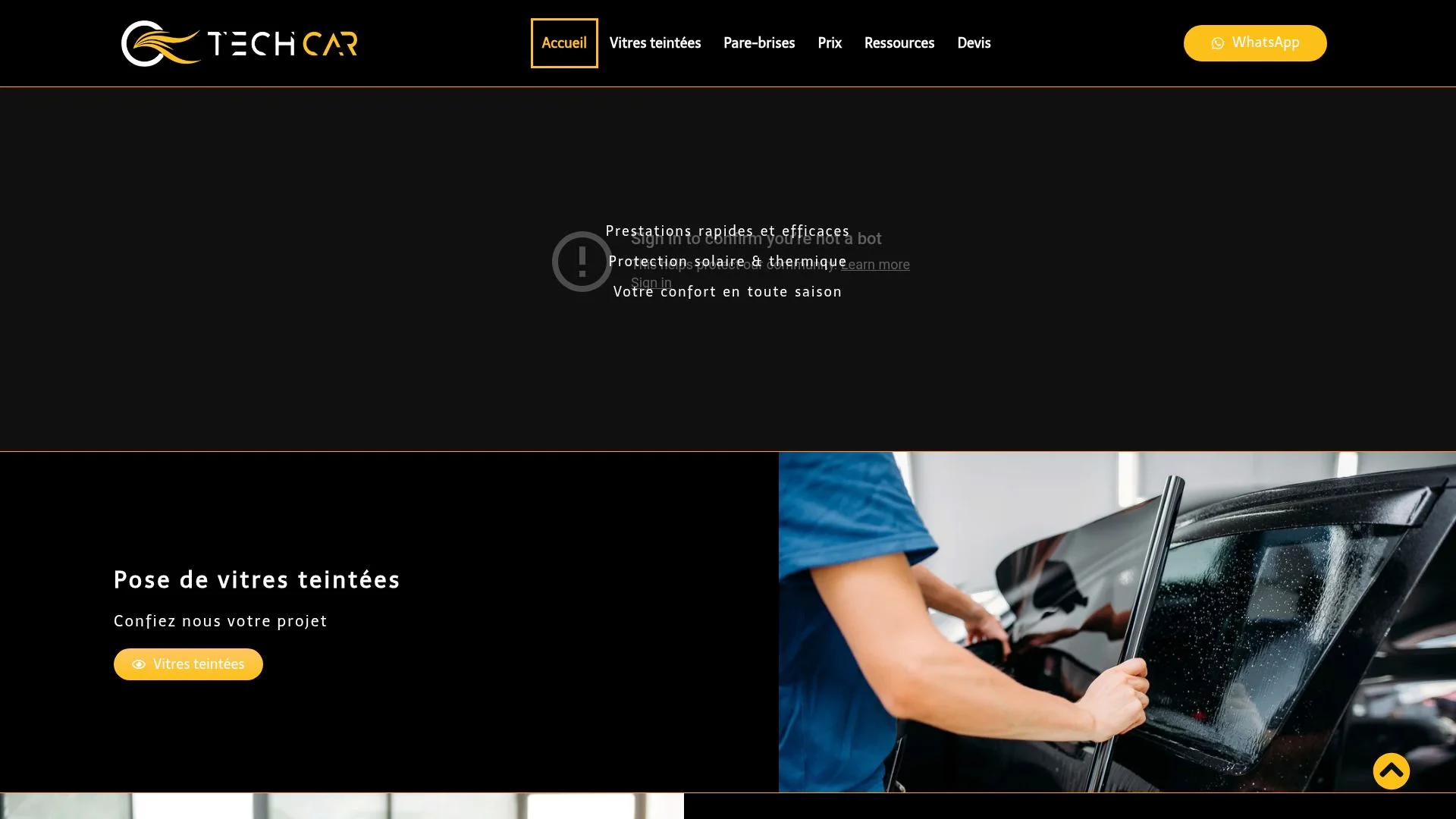 Technician installing tinted car window film on a vehicle.