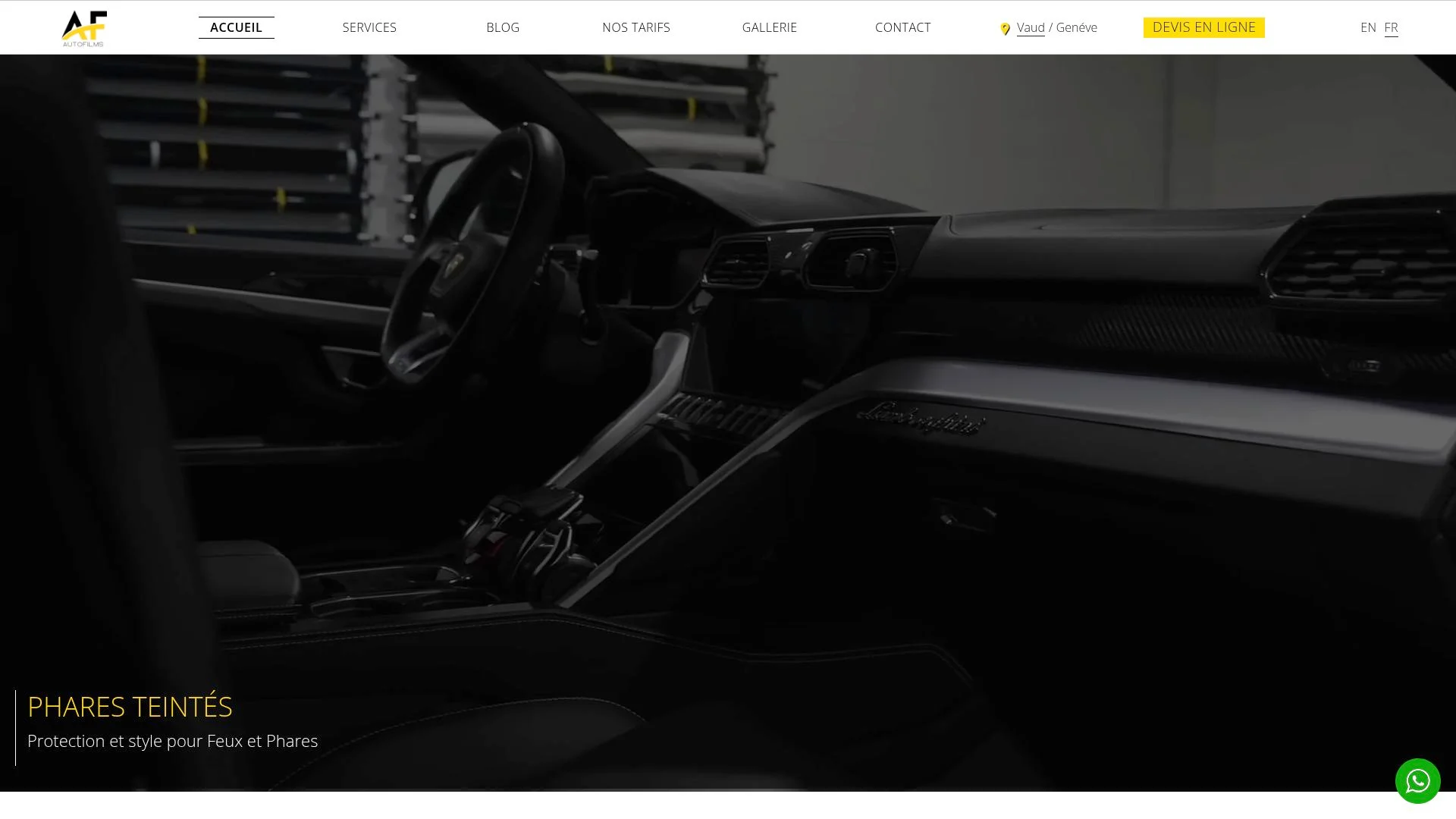 Dark, sleek, automotive interior with dashboard and steering wheel.